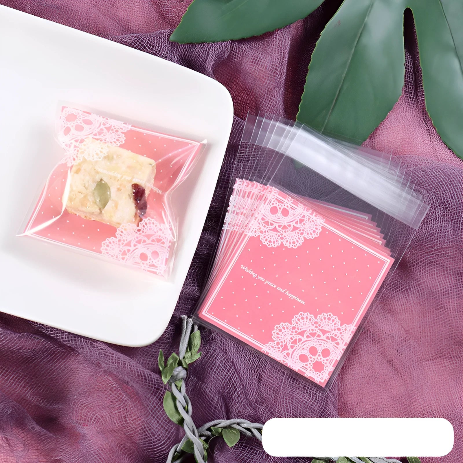 Pink self-adhesive plastic packaging bags with UV printing, shown in a pack of 100.