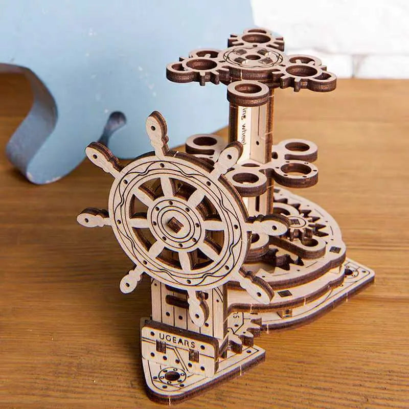 Ukrainian wooden steering wheel model rotating pen holder on a desk.