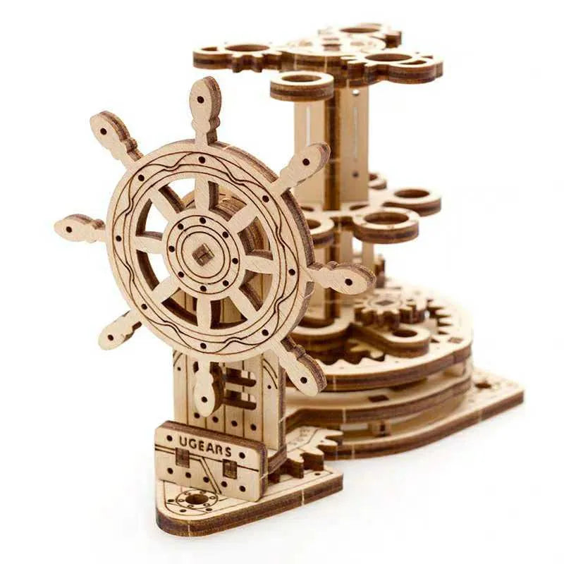 Ukrainian wooden steering wheel model rotating pen holder on a desk.