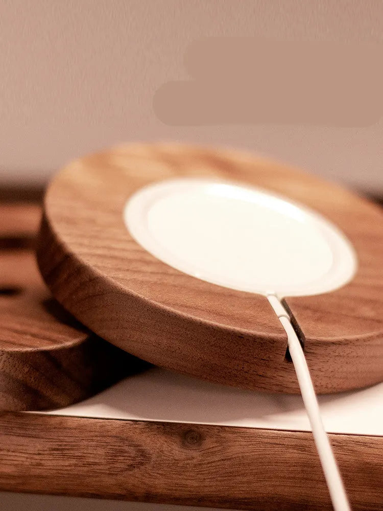 Walnut wood magnetic wireless charger base with round and square section options on desktop