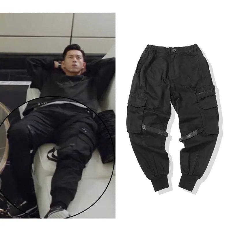 Black cotton cargo pants with tether closure, loose fit, ankle length, on a model