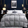 Goose down winter duvet in twill fabric shown in beige colour on a bed