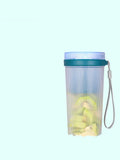Pink and green portable electric juicer cup with USB charging port and round feeding lid.