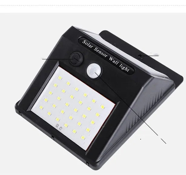 White solar-powered outdoor garden lamp with LED lights and a motion sensor on a black stake.