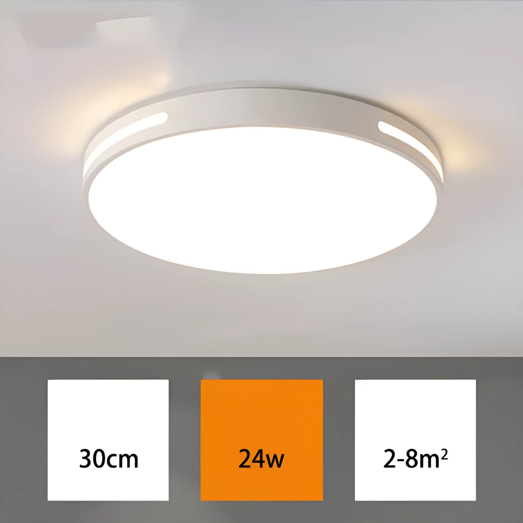 Round modern acrylic LED ceiling lamp with remote control on a white bedroom ceiling.