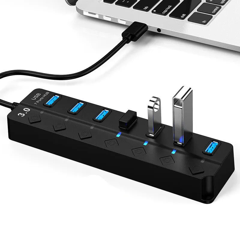 Black 7-port USB 3.0 hub with external power adapter for desktop and laptop computers.