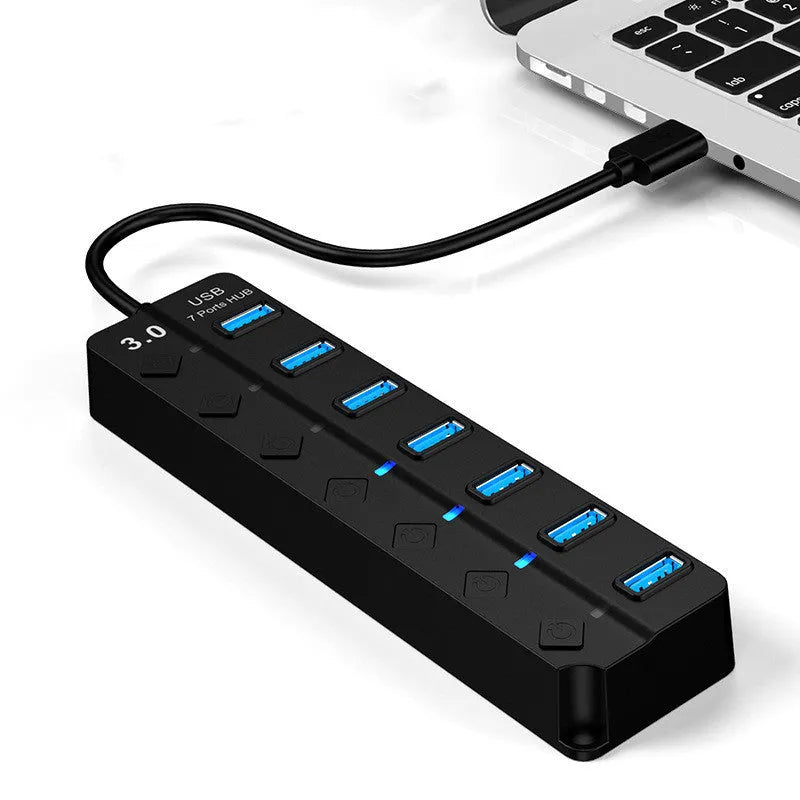 Black 7-port USB 3.0 hub with external power adapter for desktop and laptop computers.
