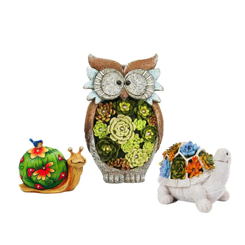 Three solar animal lights in owl, snail, and tortoise shapes on a garden window sill