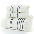 Cotton towel set showing white, grey and khaki bath towels with 34x74cm and 70x140cm dimensions