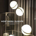 Nordic pendant light with white ball lampshade and golden fixture showing adjustable height mechanism