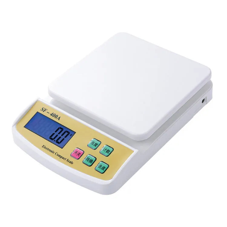 Silver electronic kitchen scale with LCD display showing weight, placed on a kitchen counter.