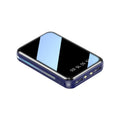 Compact digital display power bank in multiple colours showing battery percentage on screen with two USB ports.