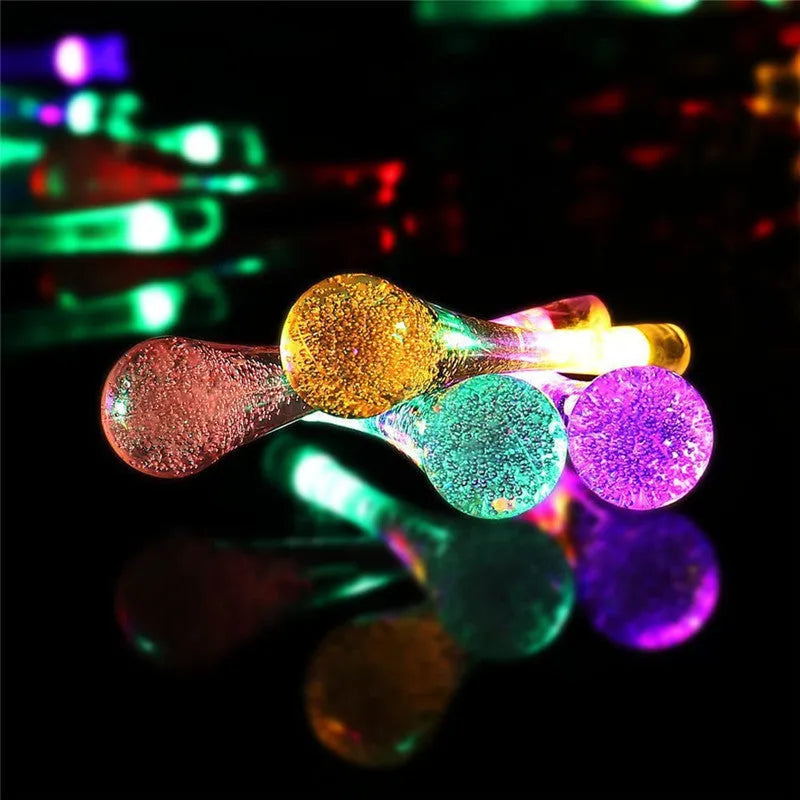 Outdoor solar LED string lights with water drop pendants on a 6.5 metre cable.