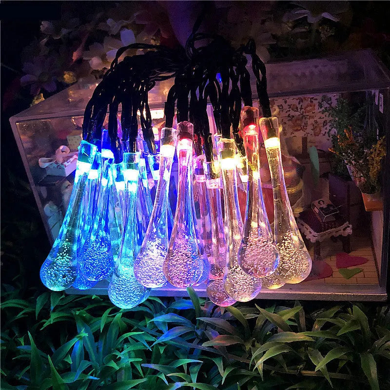 Outdoor solar LED string lights with water drop pendants on a 6.5 metre cable.