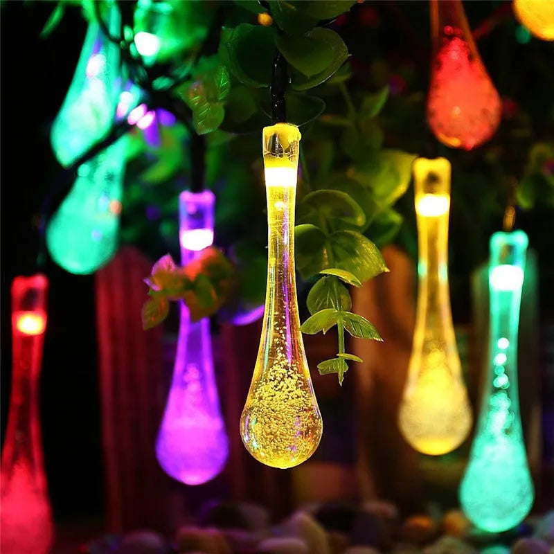 Outdoor solar LED string lights with water drop pendants on a 6.5 metre cable.