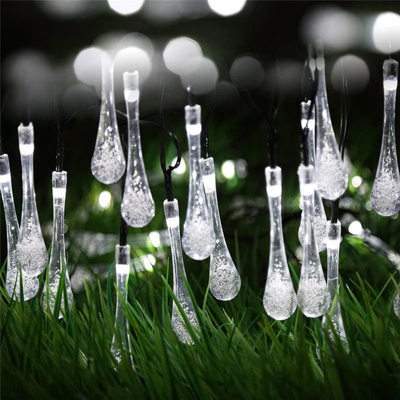 Outdoor solar LED string lights with water drop pendants on a 6.5 metre cable.