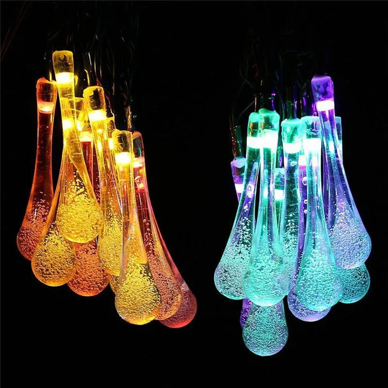 Outdoor solar LED string lights with water drop pendants on a 6.5 metre cable.