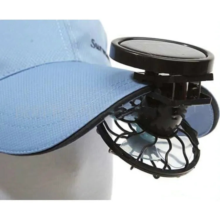 Black portable solar-powered clip fan with solar panel for outdoor cooling during camping and travel.