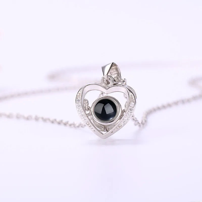 925 silver heart-shaped pendant necklace on cross chain with geometric detail and adjustable length