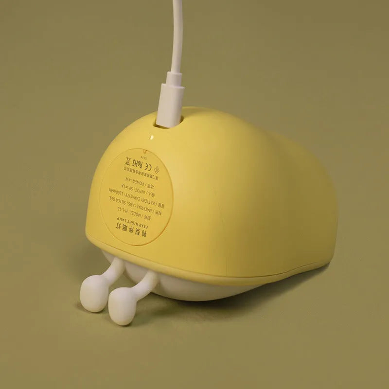 Warm yellow pear-shaped silicone bedside night light with USB charging