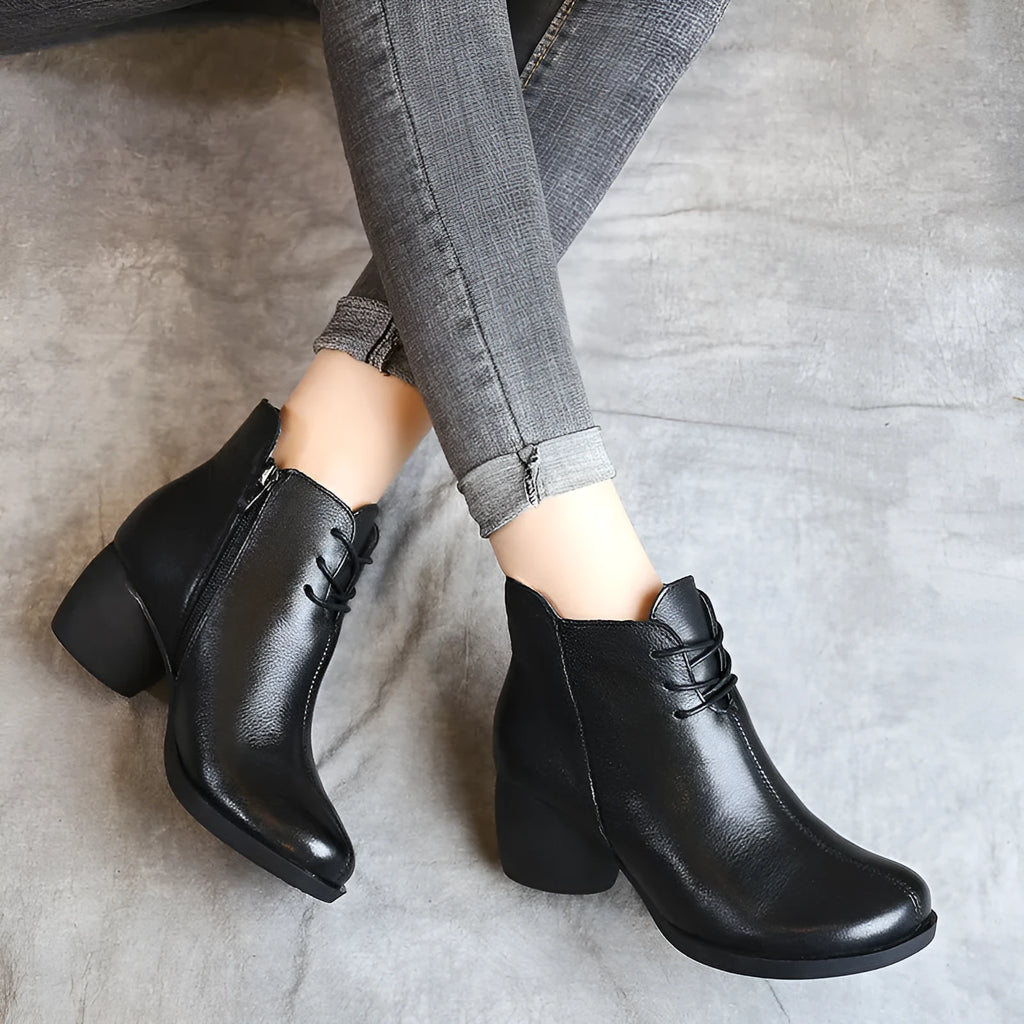 Women's brown leather Martin boots with a thick block heel and round toe on a white background.