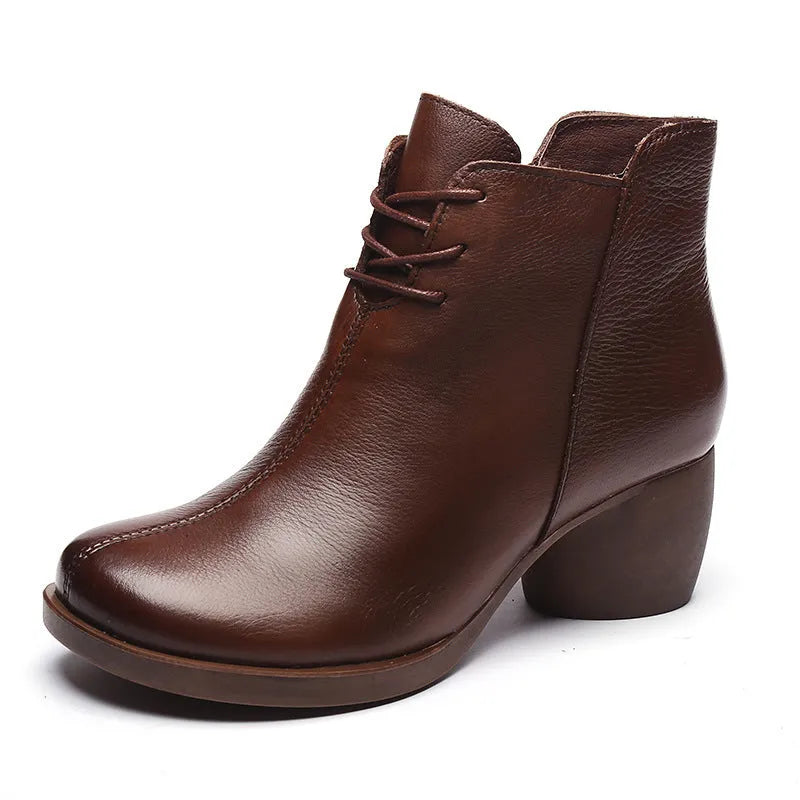 Women's brown leather Martin boots with a thick block heel and round toe on a white background.