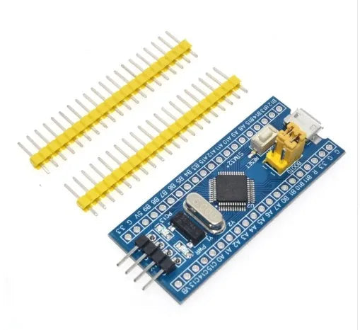 STM32F103C8T6 ARM microcontroller development board with Mini USB connector and pin headers.