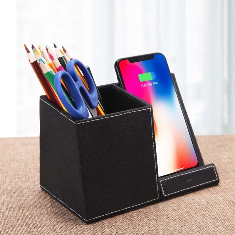 Black leather pen holder with integrated wireless phone charging pad on a desk