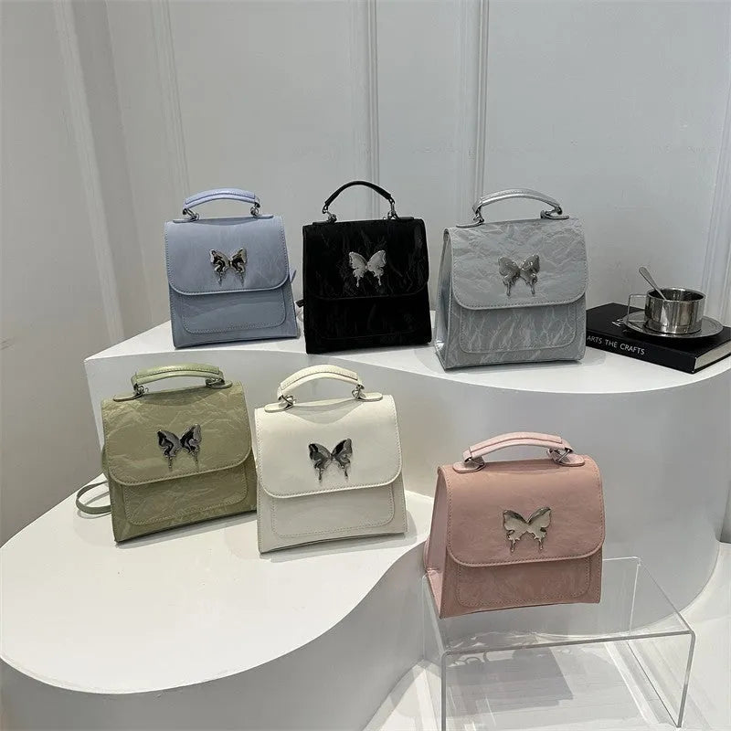 Women's preppy style hand-carry backpack in PU leather with bow detailing and mobile phone compartment