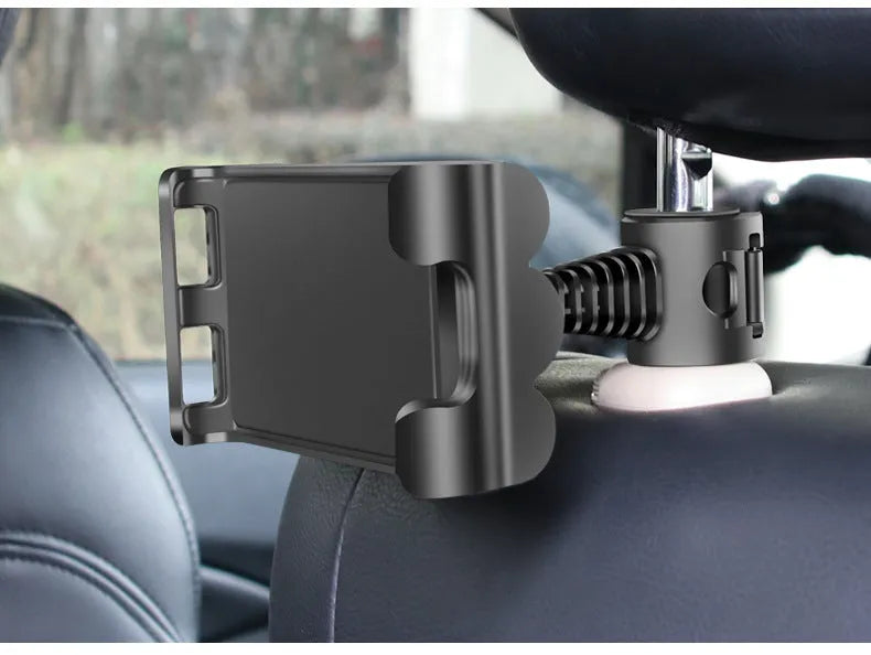 Black car headrest mount holding a tablet on the back seat, showing adjustable arm and universal bracket.