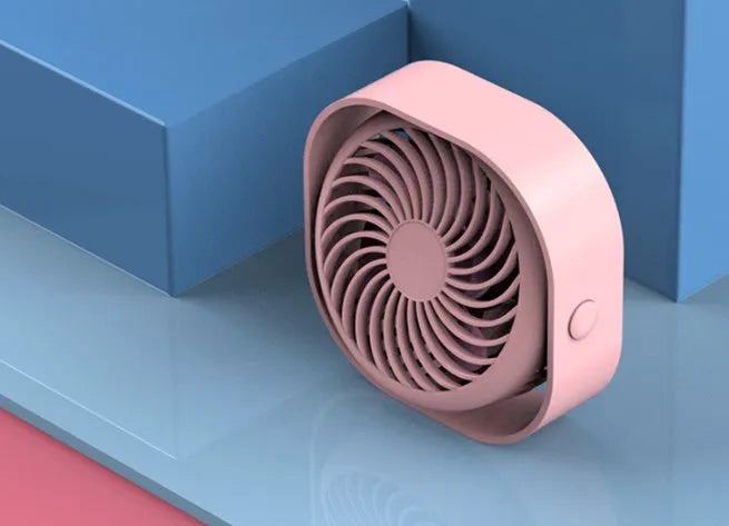 Blue USB desk fan with alarm clock display and plastic blades on a white desk.