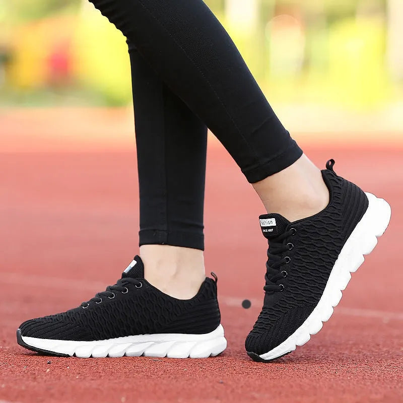 Women's running shoes with fly weaving upper in black, pink, or white colours showing breathable construction