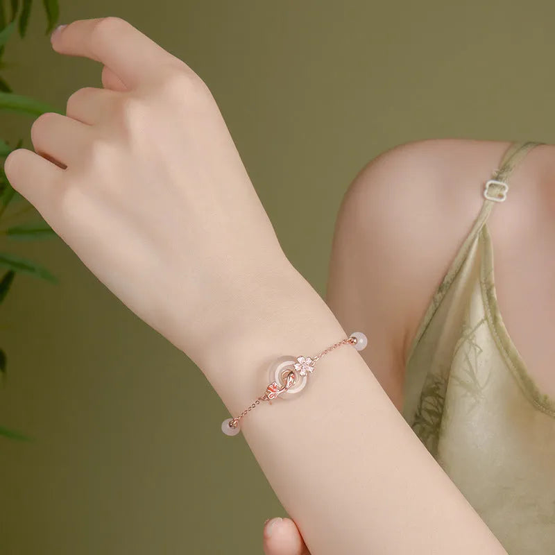 S925 sterling silver bracelet with white chalcedony flower and koi fish design in New Chinese style.