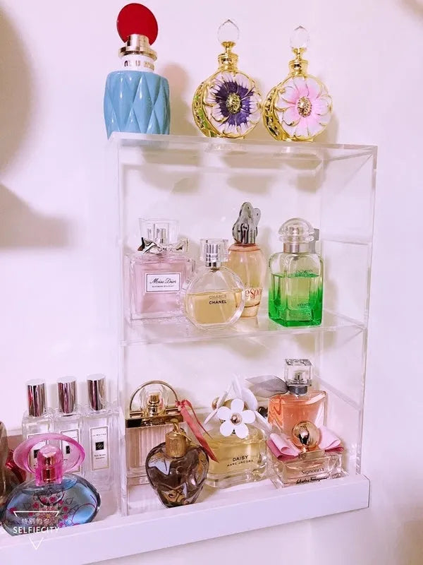 Clear acrylic cosmetics storage box 24x10x34cm on a vanity table holding makeup and skincare products