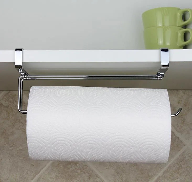 Silver stainless steel kitchen towel rack hanging on a cabinet door.
