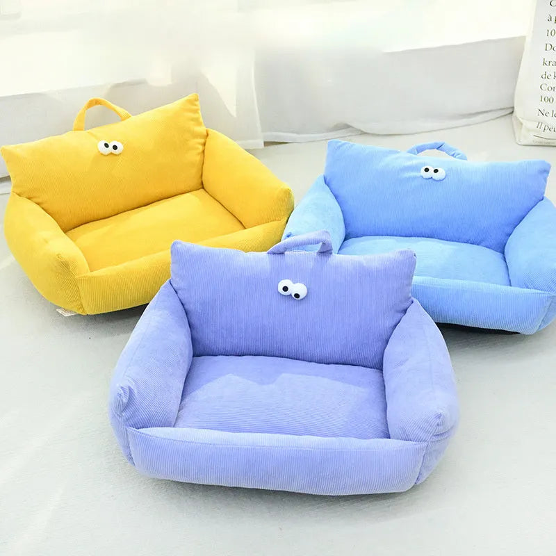 Cartoon big eye pet sofa kennel bed in blue, showing plush Moon velvet material and large adhesive eyes.
