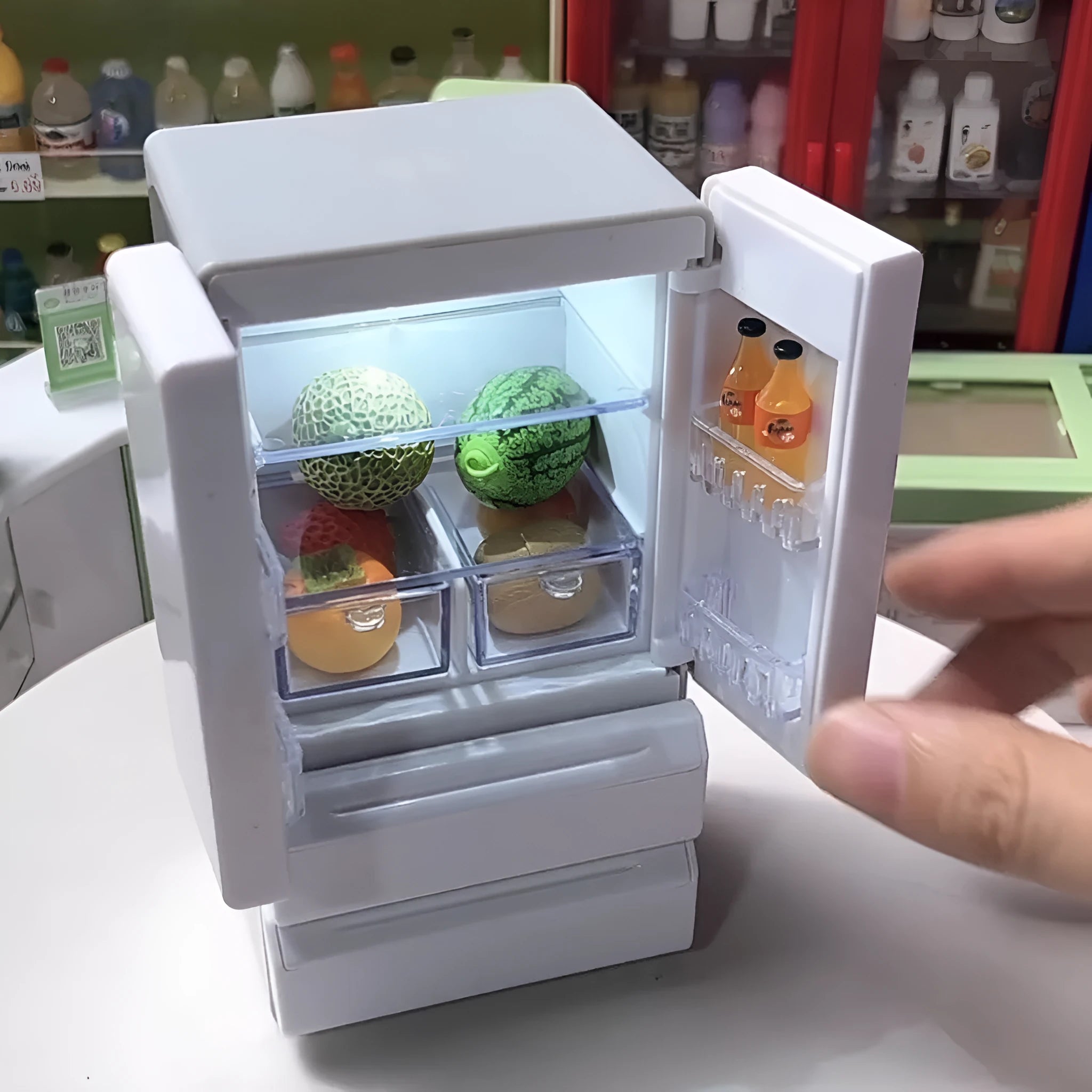 White plastic miniature candy shop toy model with illuminated interior window.