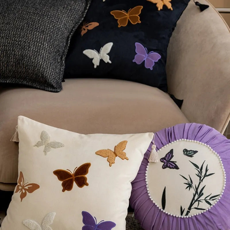 Square beige cushion with detailed black and purple butterfly embroidery in a Chinese style.