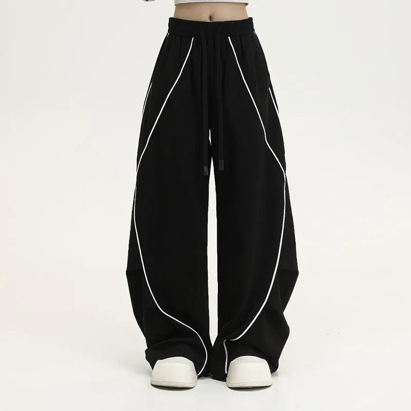 Black pleated wide-leg hip hop trousers with stripe pattern showing loose fit design