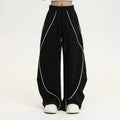 Black pleated wide-leg hip hop trousers with stripe pattern showing loose fit design