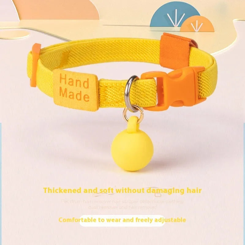 Small dog wearing a stretchy yellow polyester elastic pet collar.