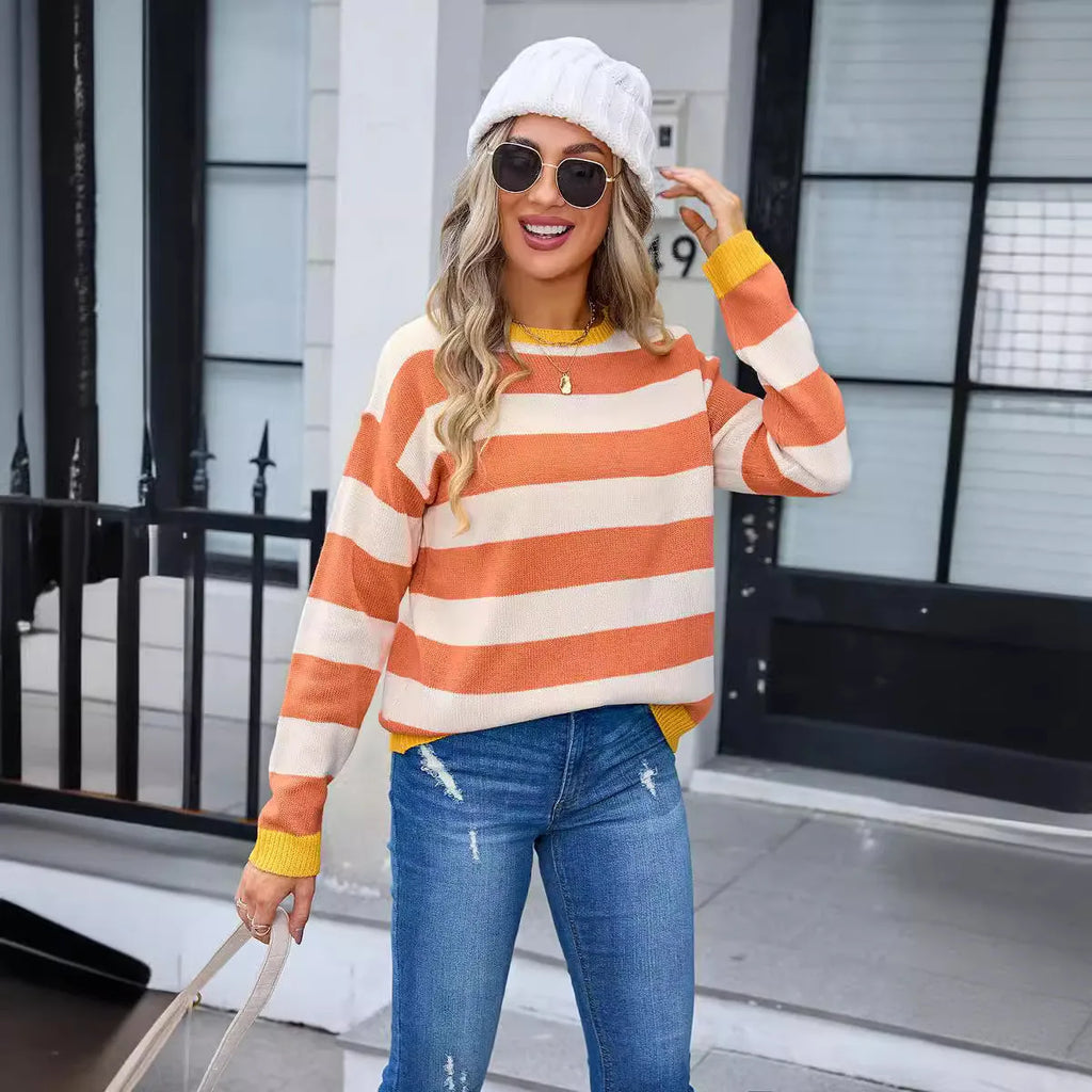 Women's loose blue acrylic sweater with striped pattern and round neck.