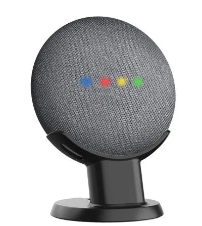 Black Google Home Mini plastic stand on a wooden desk