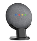 Black Google Home Mini plastic stand on a wooden desk