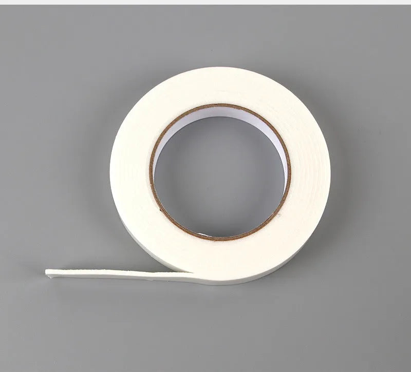 Roll of 3mm thick white foam double-sided adhesive tape showing its spongy core and strong adhesive on both sides.