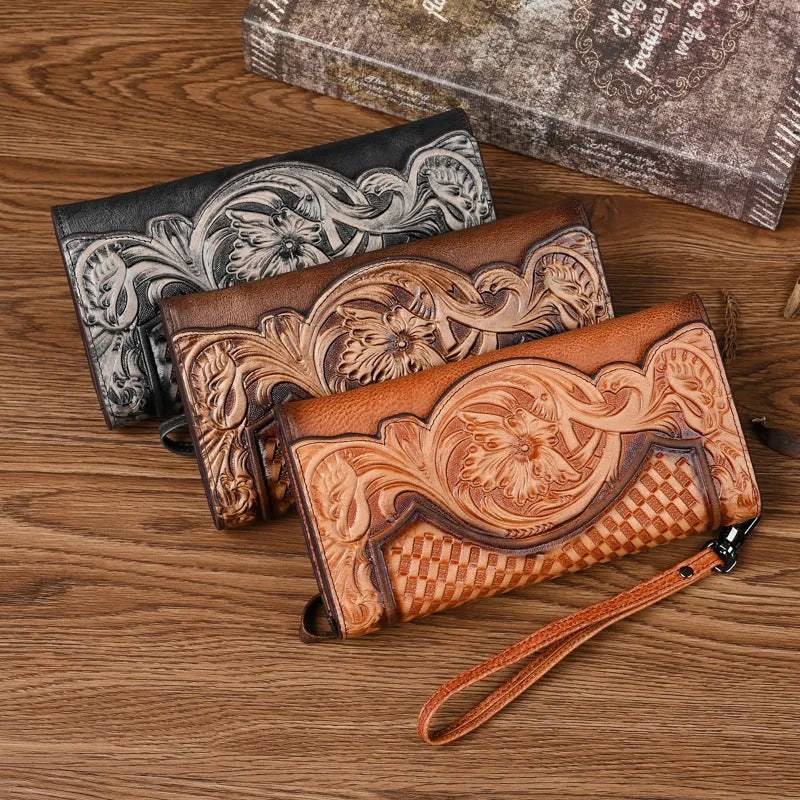 Women's brown cowhide tri-fold wallet with embossed floral pattern showing open compartments