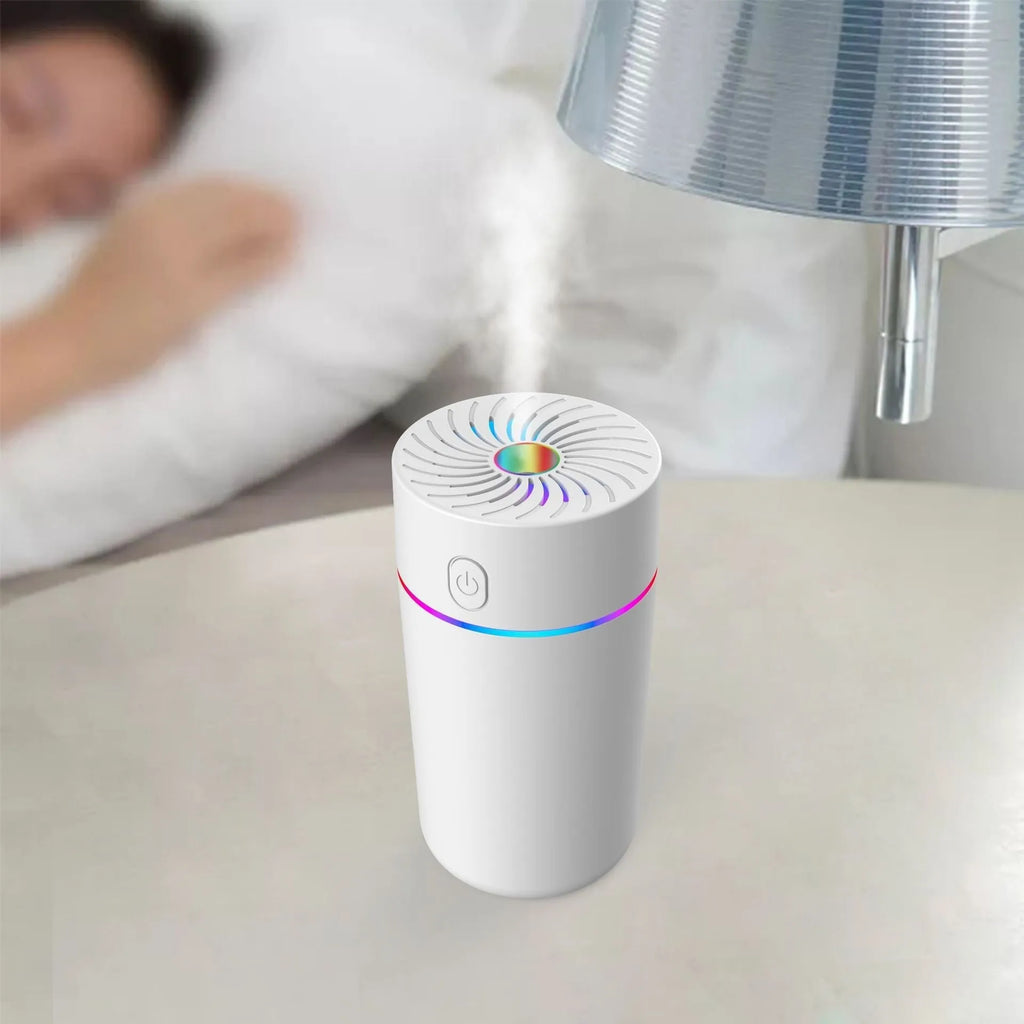Compact white car humidifier with USB cable connection and essential oil aromatherapy function