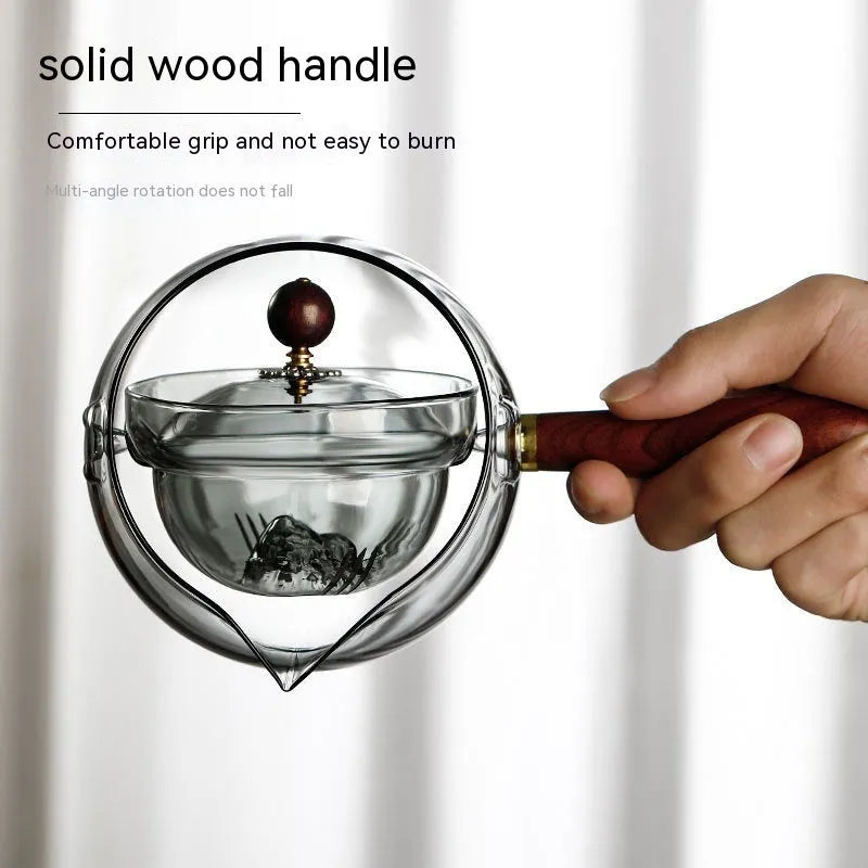 Transparent borosilicate glass teapot with wooden handle and rotation mechanism