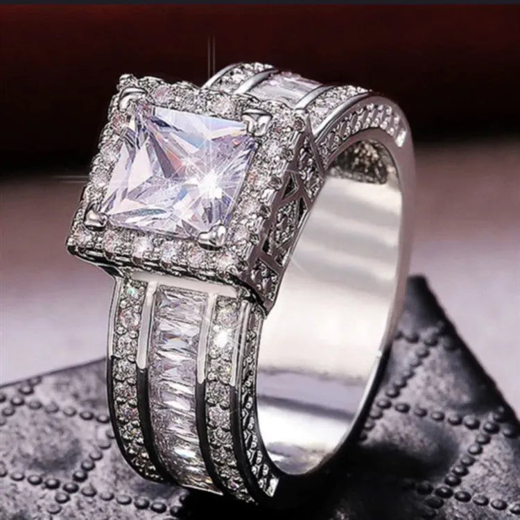 Geometric silver fashion ring for women on a hand, shown in both gold and white colour options.