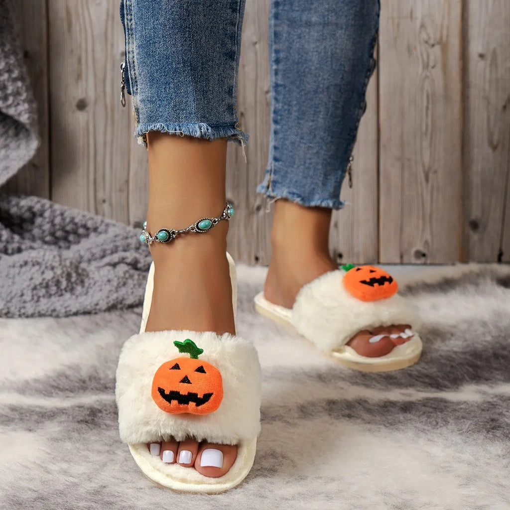 Yellow Halloween pumpkin cartoon design plush slippers with synthetic fur and a light-coloured sole.